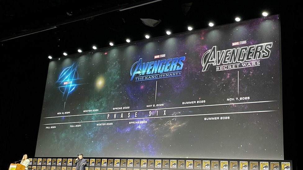 A screen shows a timeline of the Marvel Universe's Phase Six, with two new Avengers films at the end of it