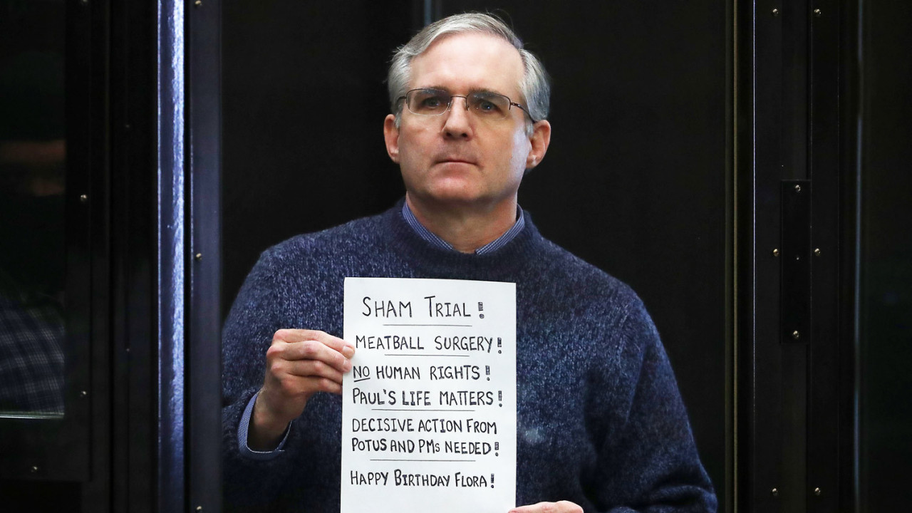 Paul Whelan holds up a sign at the end of his trial - "Sham trial! Meatball surgery! No human rights! Paul's life matters! Decisive action from potus and PMs needed! Happy Birthday Flora!"