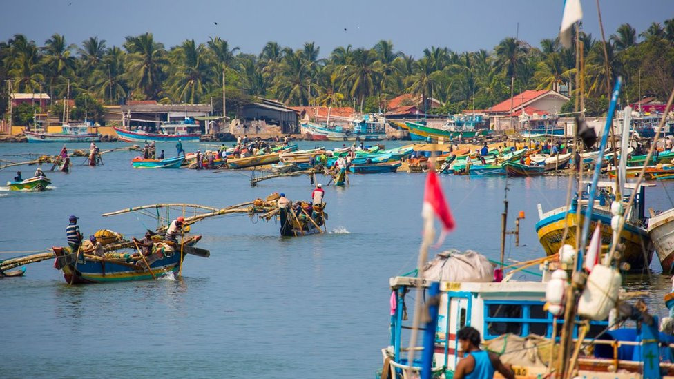 NEGOMBO, SRI LANKA - FEBRUARY 13: Cityview with harbour and fishing boats, sandy beach, souvenir shops on February 13, 2014 in Negombo, Sri Lanka. (Photo by EyesWideOpen/Getty Images)