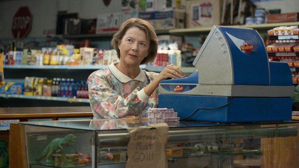 Annette Bening by a ticket machine in a scene of Jerry & Marge Go Large