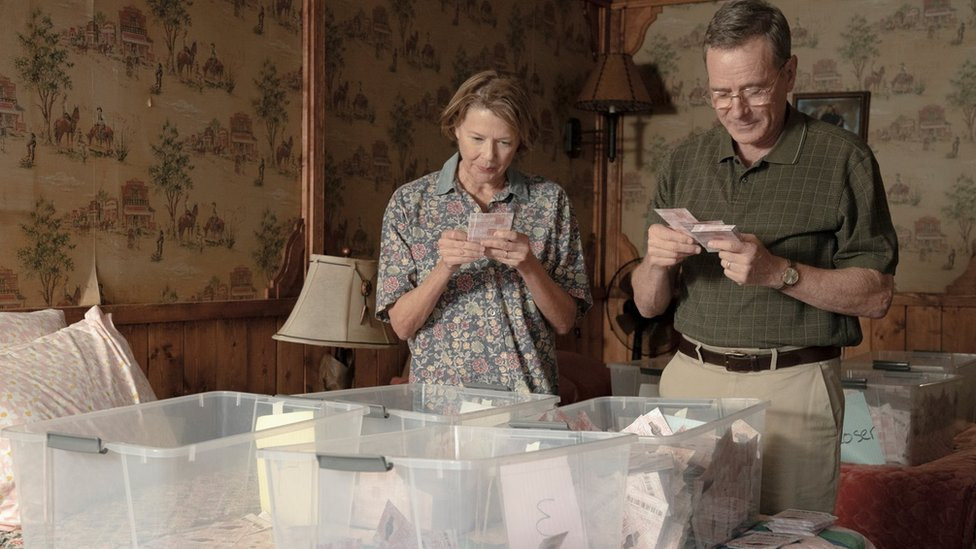 Bryan Cranston and Annette Bening look at lottery tickets in a scene of Jerry & Marge Go Large