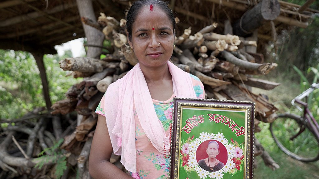 Samjhana holds a photo of her mother-in-law