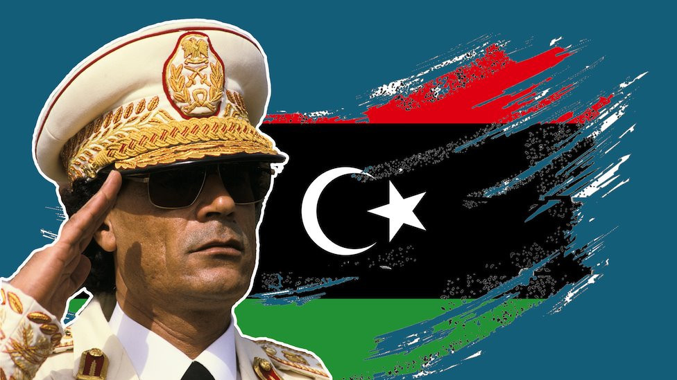 Image of Muammar Gaddafi over a treated flag of Libya
