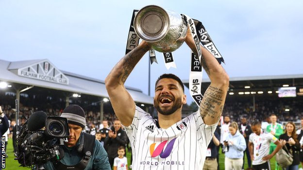 Aleksandar Mitrovic lifts the Championship trophy
