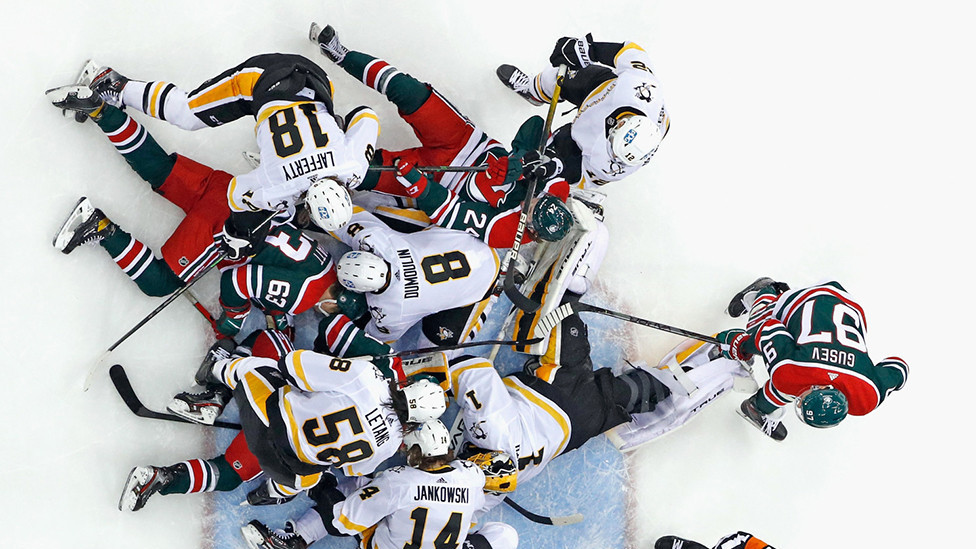 Hokejaši Pitsburg Pingvina brane se od napada domaćih Nju Džersi Devilsa u trećoj trećini meča Nacionalne hokejaške lige Amerike