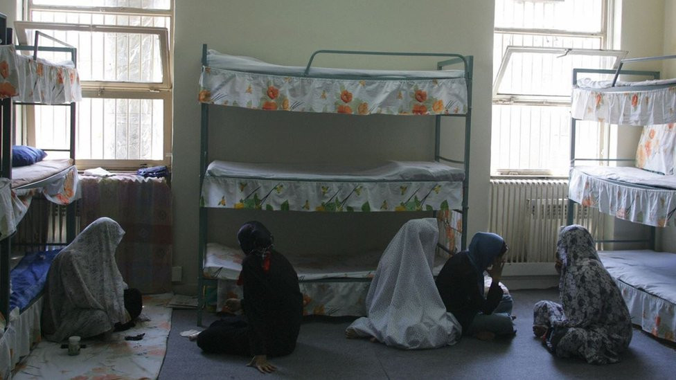 Iranian women inmates sit at their cell in the Evin jail