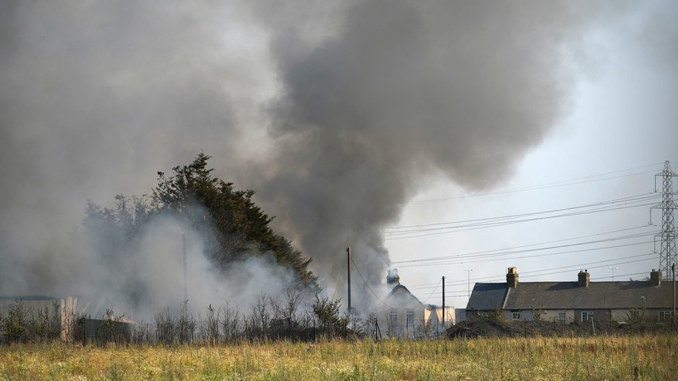A house on fire in Wennington, east London, UK on 28 July 2022