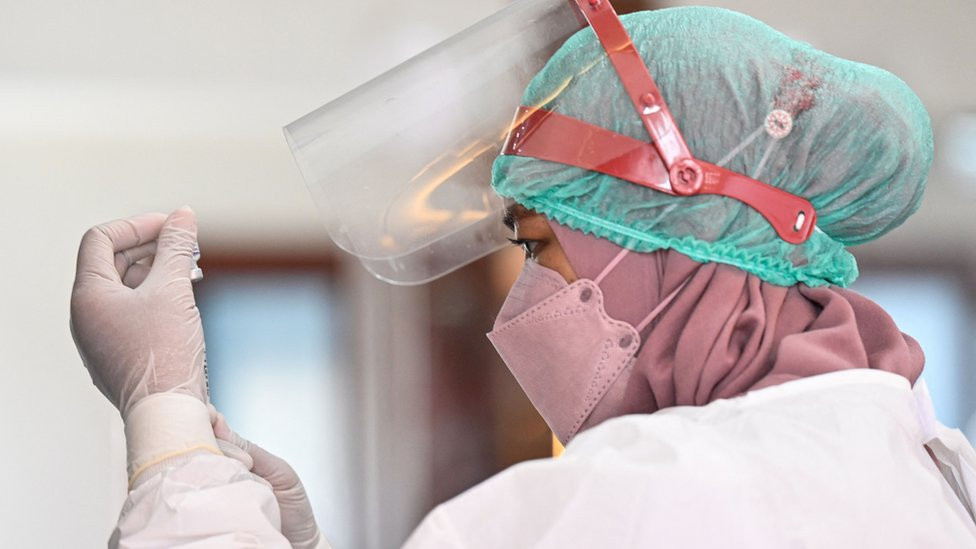 A nurse prepares a booster dose of the Pfizer Covid-19 vaccine in Jakarta