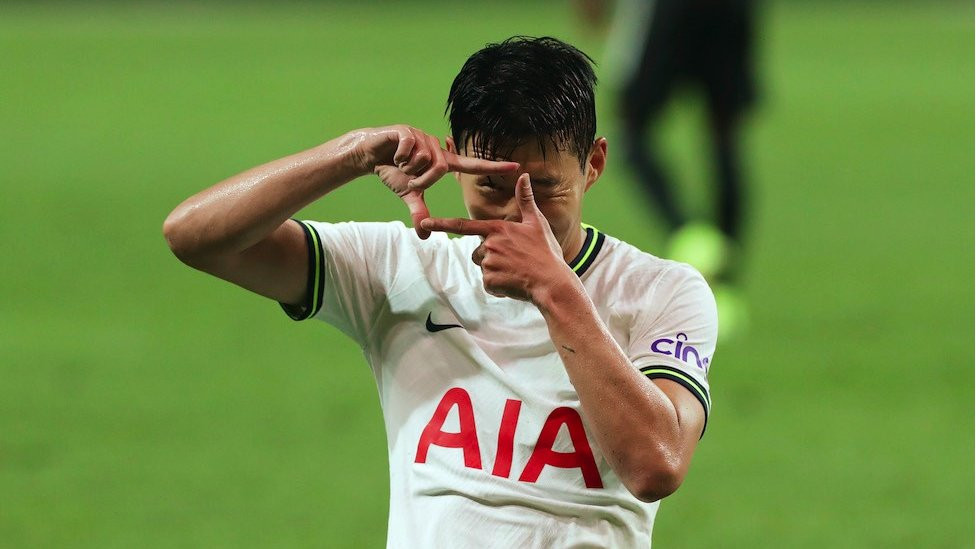 Male footballer Son Heung-Min holds his fingers up in the shape of a camera