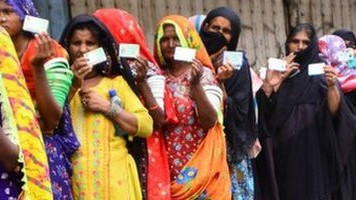 Flood victims queue up outside a bank to receive financial assistance in southern Sindh province