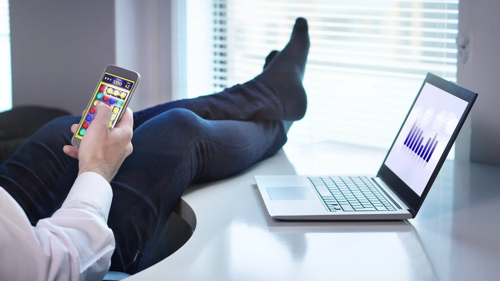 Man looking at phone while at work