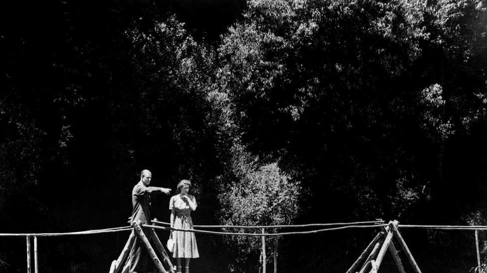 Princess Elizabeth and the Duke of Edinburgh pause on the rustic bridge in the grounds of the Royal Lodge, Sagana, their wedding present from the people of Kenya.