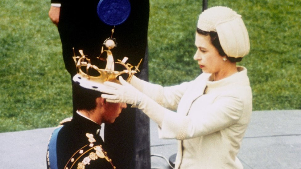 Queen Elizabeth II formally invests her son Prince Charles with the Coronet of the Prince of Wales during a ceremony at Caernarfon Castle in Cardiff