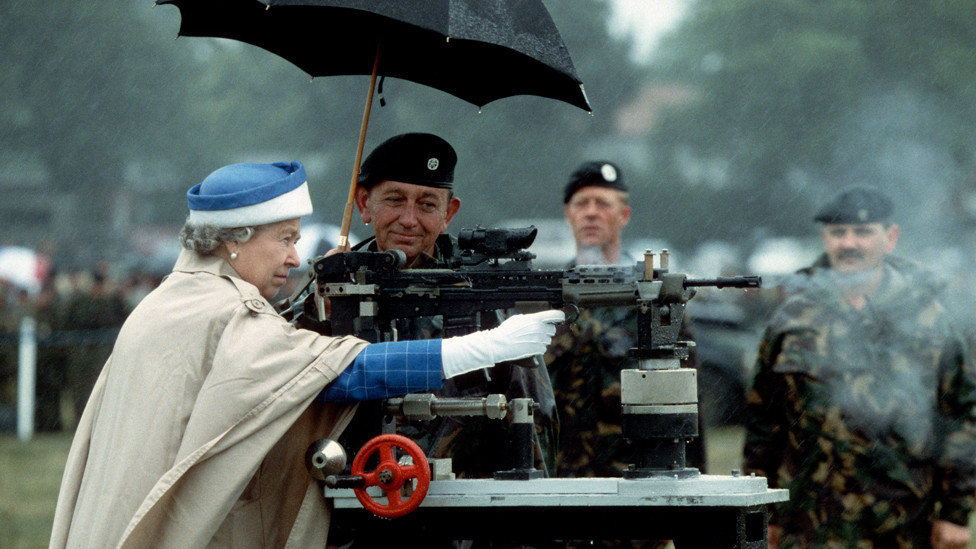 HM Queen Elizabeth II fires a rifle during a visit to the Army rifle association at Bisley, England July 1993