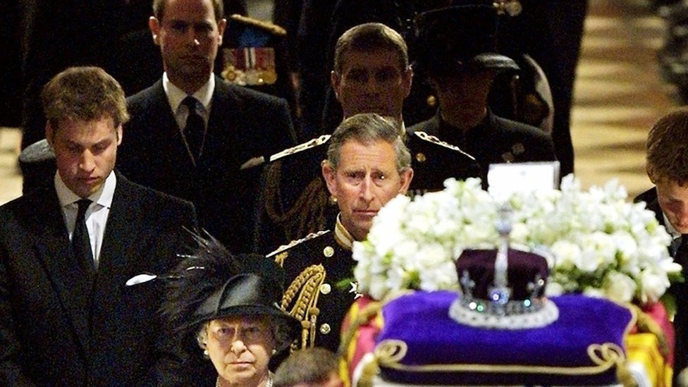 Queen Elizabeth II (front, C) leads her family as she follows pall bearers carrying the coffin of Queen Elizabeth, the Queen Mother out of Westminster Abbey after the funeral service in London 09 April 2002.