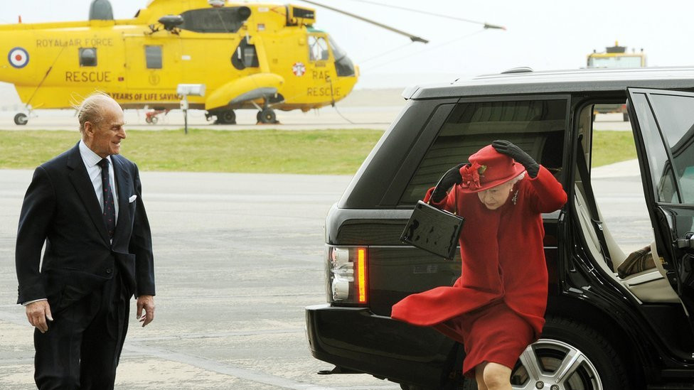 Britain's Queen Elizabeth II and the Duke of Edinburgh arrive at a windy RAF Valley in Anglesey, to visit their grandson Prince William at the base.
