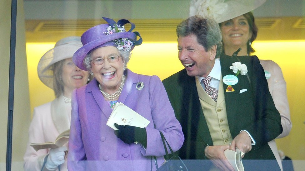 Britain's Queen Elizabeth II with her racing manager John Warren after her horse, Estimate, won the Gold Cup, 2013