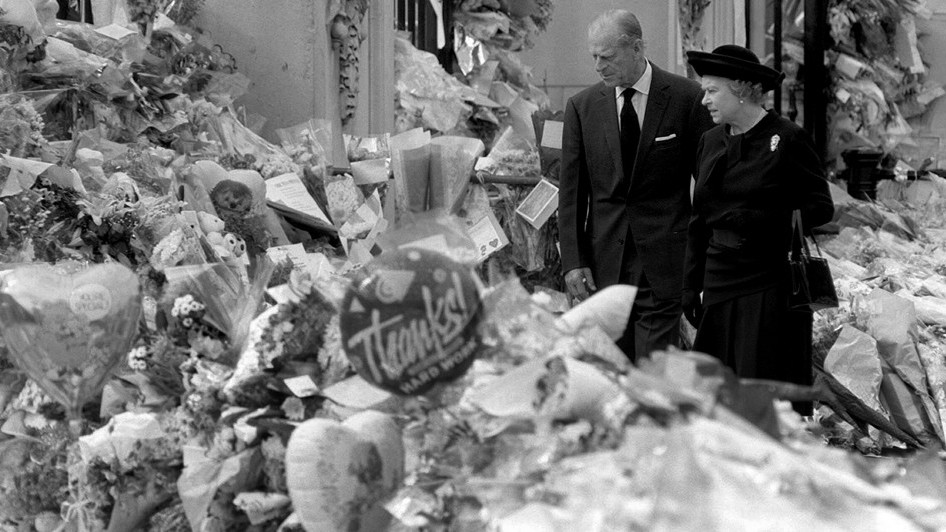 Queen Elizabeth II and the Duke of Edinburgh view the floral tributes to Diana, Princess of Wales, at Buckingham Palace.