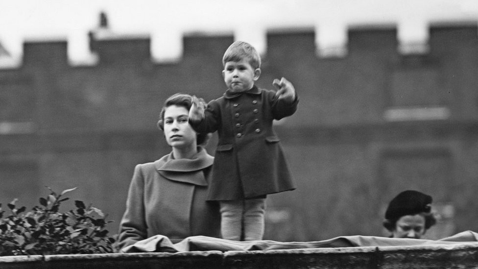 Princess Elizabeth (later Queen Elizabeth II), left, and Prince Charles watching a procession, during the visit of Queen Juliana of the Netherlands, from the wall of Clarence House, London, 22nd November 1950.