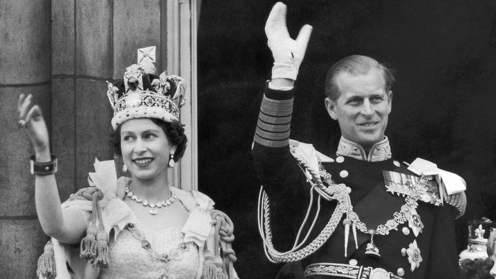 The Queen and the Duke of EDINBURGH wave from the famous balcony at Buckingham Palace to the vast crowds massed outside the Palace on June 2 1953