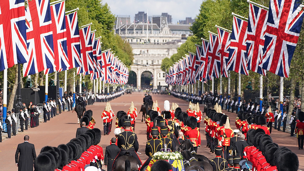 King Charles III and members of the royal family behind Queen Elizabeth II's flag-draped coffin as it is taken in procession on a Gun Carriage of The King's Troop Royal Horse Artillery from Buckingham Palace to Westminster Hall on 14 September 2022
