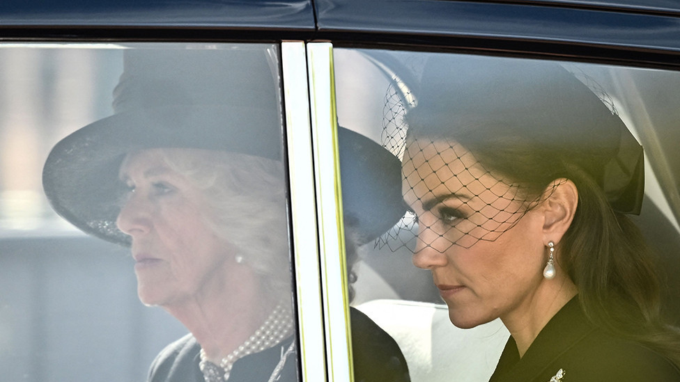 Camilla, Queen Consort and Catherine, Princess of Wales are driven behind the coffin of Queen Elizabeth II during a procession from Buckingham Palace to the Palace of Westminster, in London on 14 September 2022