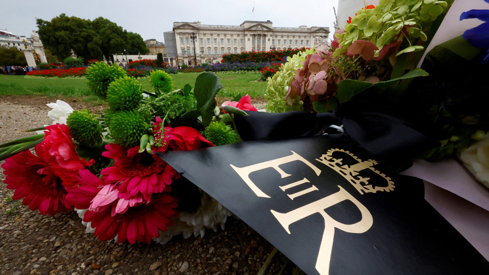 Floral tributes with the royal cypher of Britain's Queen Elizabeth are seen outside Buckingham Palace, following the queen's death, in London, Britain September 13, 2022.