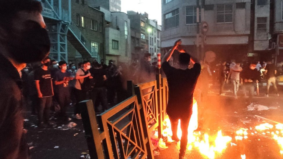 People clash with police during a protest following the death of Mahsa Amini, in Tehran, Iran (21 September 2022)