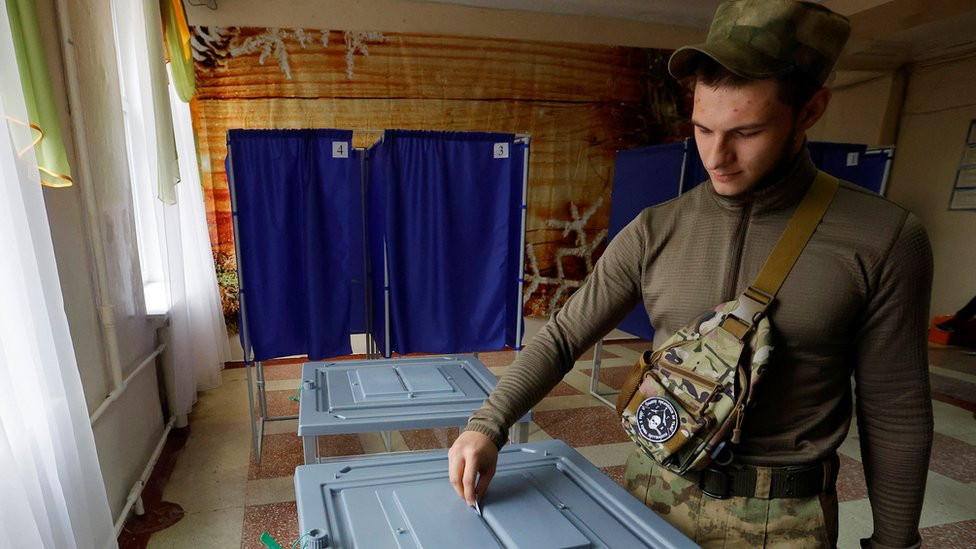 A service member of the self-proclaimed Donetsk People's Republic (DPR) casts his ballot at a polling station during a referendum on the joining of DPR to Russia, in Donetsk, Ukraine 27 September