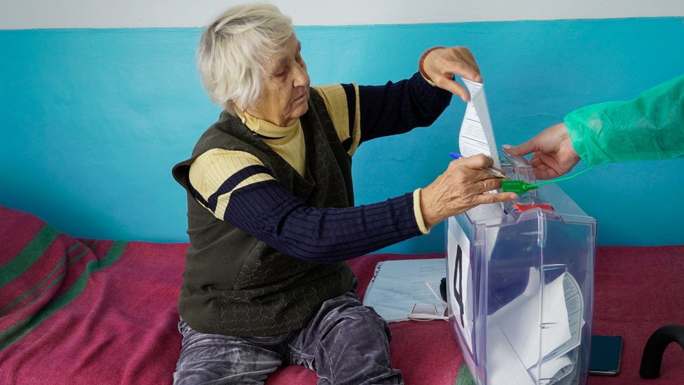 A woman casts her ballot during voting in a so-called referendum on the joining of Russian-controlled regions of Ukraine to Russia, in a hospital in Berdyansk, Zaporizhzhia region