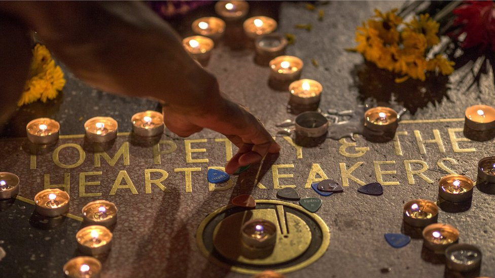A man touches the Tom Petty and the Heartbreakers star on The Hollywood Walk of Fame after Petty suffered a massive heart attack last night that left him in very grave condition, on October 2, 2017