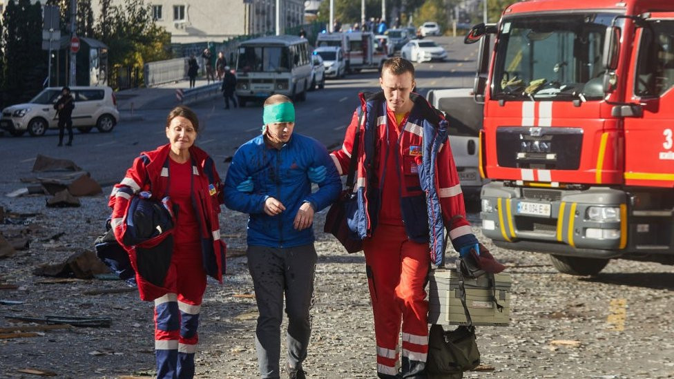 First responders guide an injured person in Kyiv