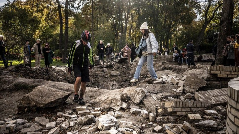 People visit a crater in Kyiv