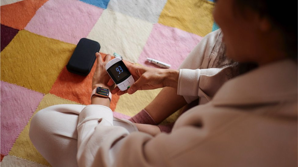 Women using glucometer that works with smart devices
