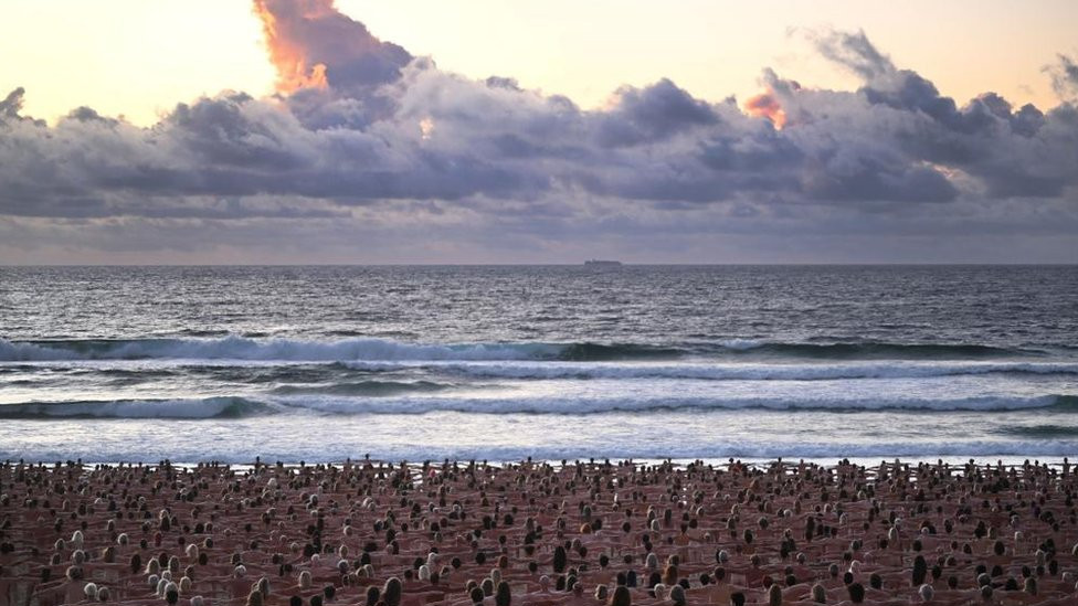 People pose naked on Bondi Beach, Australia