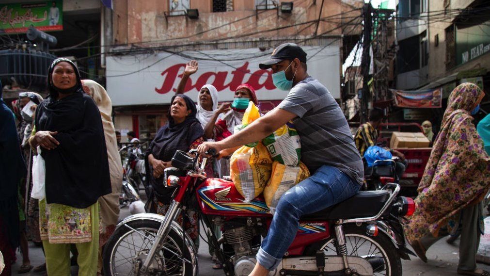 LAHORE, PAKISTAN - APRIL 14: People wait outside a shop to receive food rations on the first day of Ramadan on April 14, 2021 in Lahore, Pakistan. Several cities in Pakistan went back under partial lockdowns ahead of Ramadan due to an uptick in coronavirus cases. Mosques in Pakistan will remain open during the holy month. (Photo by Betsy Joles/Getty Images)