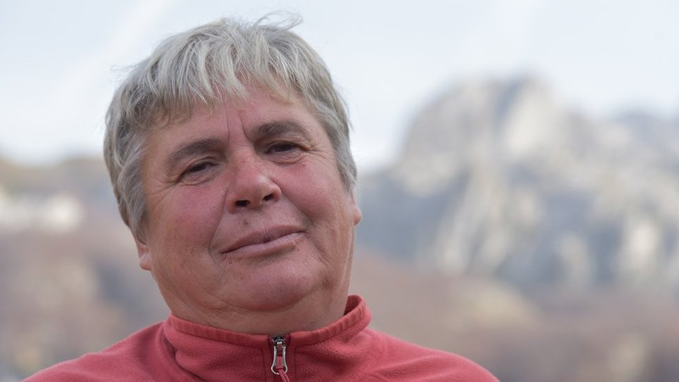 Gjystina standing in front of the mountains