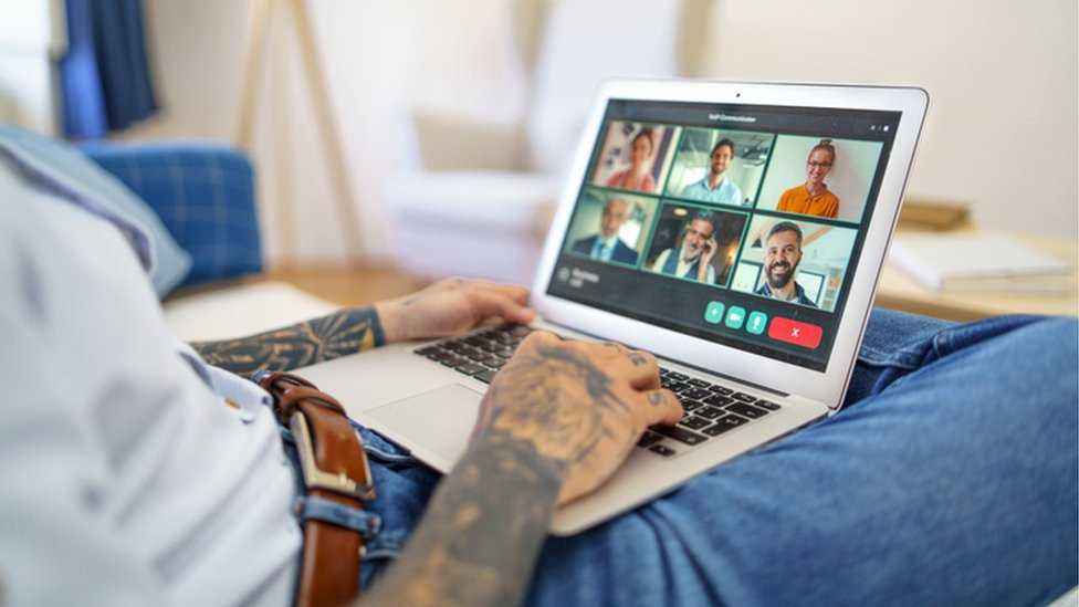 A man with a laptop on his lap