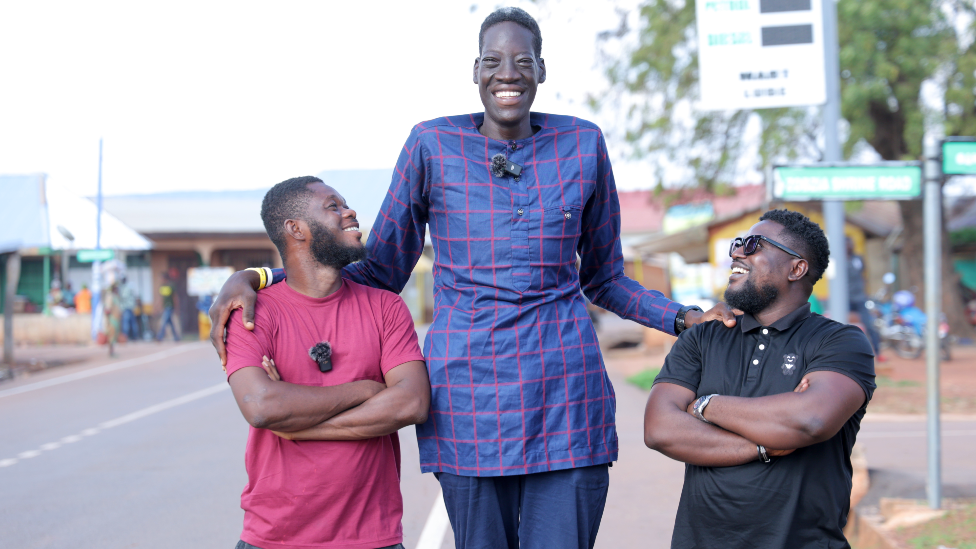 Awuche pictured between two BBC employees