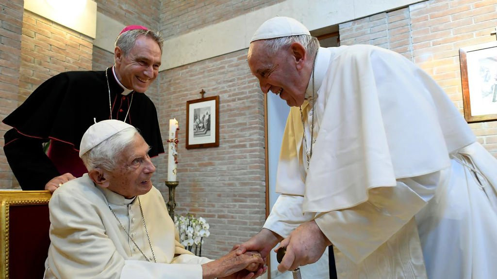 Benedict and Francis greeting each other at a meeting in the Vatican