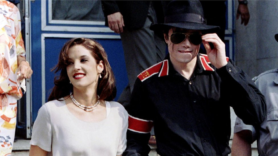 Pop star Michael Jackson and his bride Lisa Marie Presley-Jackson hold each others hands outside Heim Pal Children's Hospital where they distributed toys in Budapest, Hungary August 6, 1994