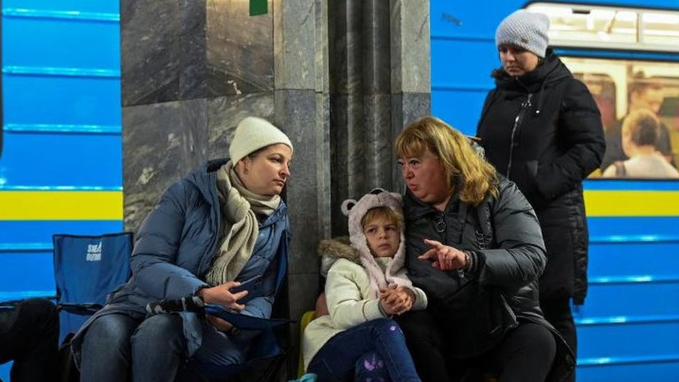 People take shelter inside a metro station during massive Russian missile attacks in Kyiv
