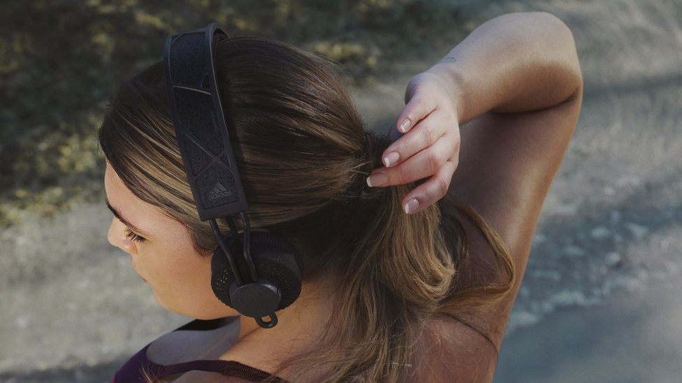 A model wearing Adidas' solar-powered headphones