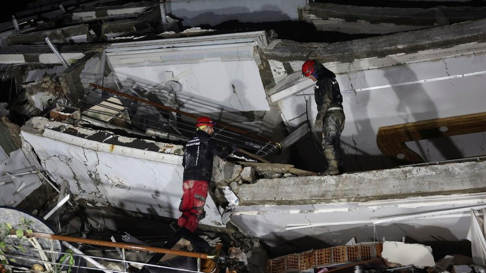 A rescue team works on a collapsed building, following an earthquake in Antakya, Turkey