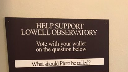 Picture of Lowell Observatory's tip boxes which prompt visitors to voice their opinion on Pluto's status