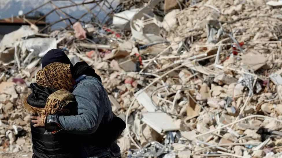 People hugging in the ruins after the earthquake