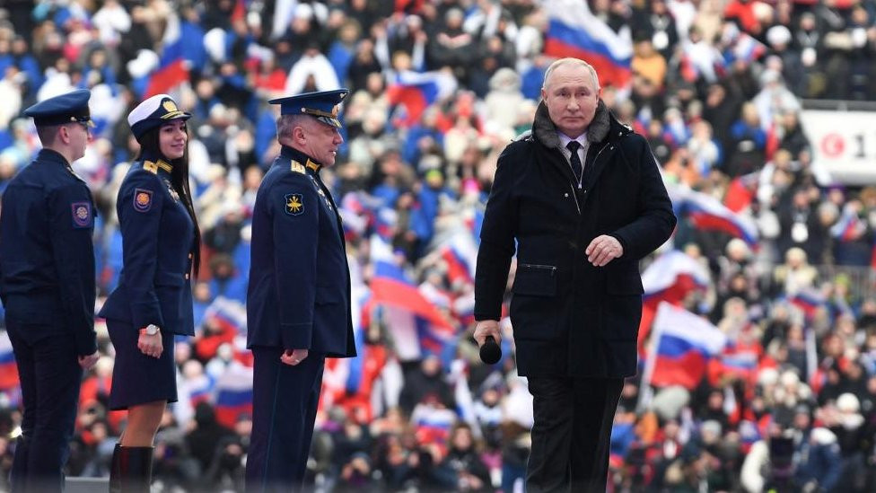 Russian President Vladimir Putin is seen on stage at a concert at Luzhniki Stadium in Moscow, Russia February 22, 2023.
