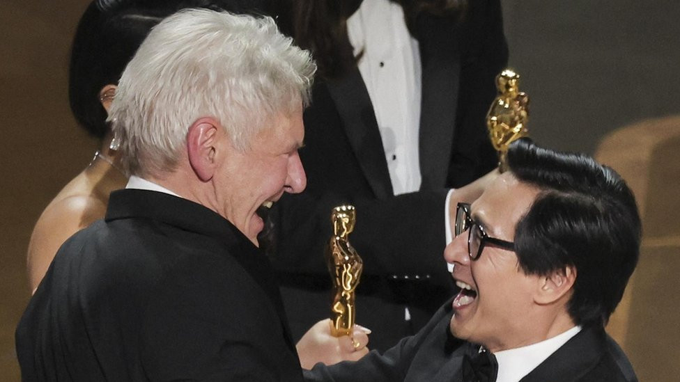 Ke Huy Quan receives the Oscar for Best supporting actor from Harrison Ford after "Everything Everywhere All at Once" won during the Oscars show at the 95th Academy Awards in Hollywood, Los Angeles, California, U.S., March 12, 2023