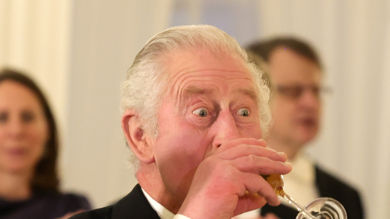 King Charles drinks from a Champagne flute during a state banquet at the Bellevue Palace