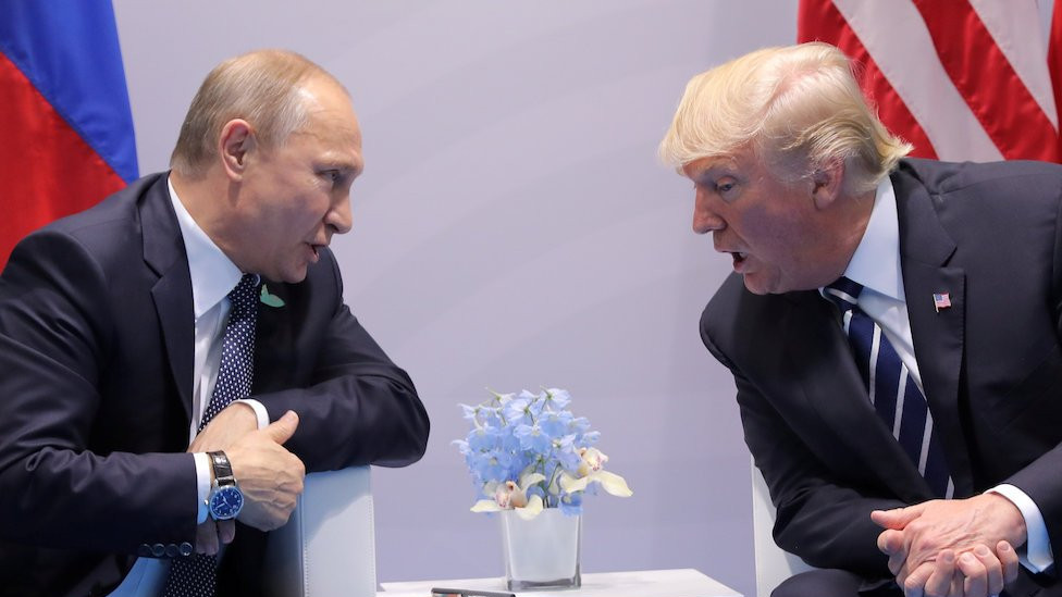 Putin and Trump sit across from each other